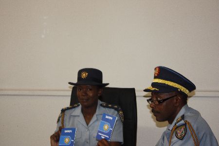 Windhoek, 29 March 2012-Inspector Kauna Shikwambi and Deputy Commissioner Edwin Kanguatjivi of the Namibian Police Force (NamPol) displaying the newly-published booklets containing a wide range of safety and crime prevention tips to the media here on Thursday.(photo by Simon Kopper Endjala) NAMPA