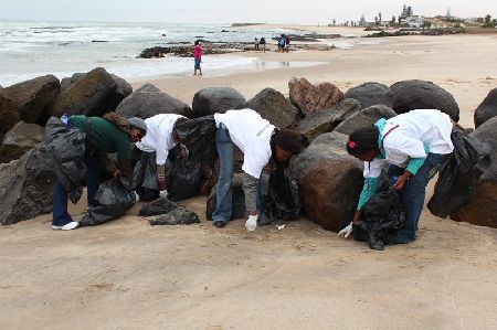 SWAKOPMUND, 15 September 2012 - Volunteers from the Hosea Katako culture group, participating in the national coastal clean-up day here on Saturday. (Photo by: Carike Freygang) NAMPA