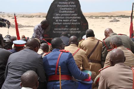 SWAKOPMUND, 29 March 2014 - The lives of OvaHerero/OvaMbanderu and Nama people who perished during the 1904-1908 genocide were commemorated at Swakopmund in the Erongo Region on Saturday. Here OvaHerero Paramount Chief Kuaima Riruako and a number of OvaHerero/OvaMbanderu and Nama community members at a memorial stone erected in honour of the deceased at the old Swakopmund cemetery. (Photo by: Joseph Nekaya) NAMPA 