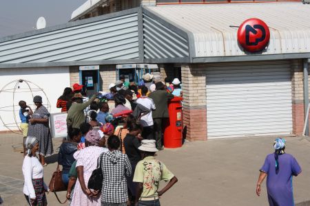 WINDHOEK, 04 AUG (NAMPA) - Pensioners and persons living with disabilities line up at the Namibia Post Limited (NamPost) Katutura Branch to receive their monthly State grants and pension back-pay totaling N. dollars 2 600. President Hage Geingob, in his State of the Nation Address in April this year, said one of the first priorities of the new government was to increase the old age pension by 66.7 per cent (from N. dollars 600 to N. dollars 1000), starting this 2015/2016 financial year. Further increases will be affected so that old age pension grants reach N.dollars 1 200 by 2017. (Photo by George Hendricks) NAMPA