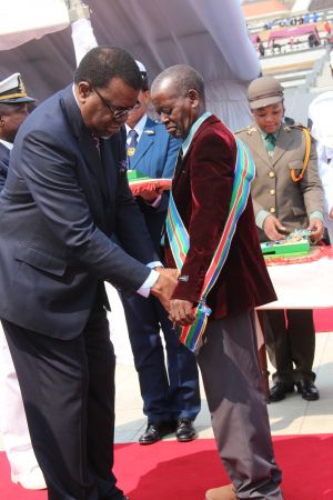 WINDHOEK, 26 August 2015 - President Hage Geingob confers the Most Distinguished Order of Namibia First Class on former Robben Island Political Prisoner, Heikki Shililifa, during the 49th commemoration of Heroes' Day. (Photo by: Joseph Nekaya) NAMPA