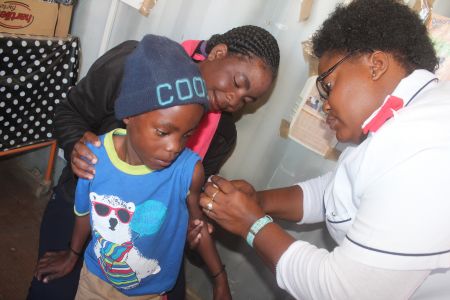 OTJIWARONGO, 11 July 2016 - A nurse at the DRC informal settlement State Clinic, Memory Ruzo (R) injects seven-year-old Tulimeameno Shaaninka against measles/rubella. The vaccination campaign runs from 11 to 22 July 2016 countrywide. (Photo by: Mulisa Simiyasa) NAMPA 