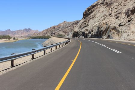 ROSH PINAH, 20 October 2017 – A section of the newly-built Rosh Pinah-Oranjemund tar road nestles between the Orange River and rocky hills. (Photo by: Patience Smith) NAMPA