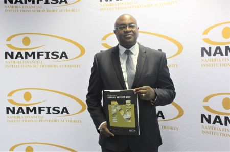 WINDHOEK, 03 August 2018 - The Chief Executive Officer of Namfisa, Kenneth Matomola pictured with the authority's Annual Report on Thursday. (Photo by: Linea Dishena) NAMPA