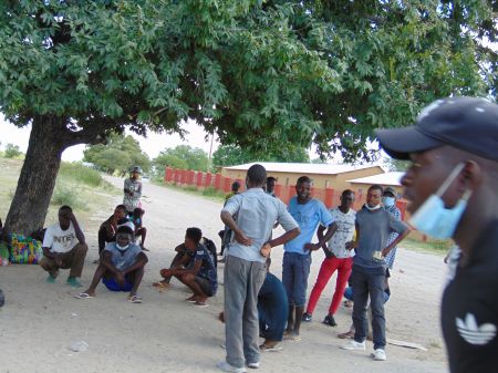 OSHIKANGO, 05 March 2021 - Some of the young men from Angola camping under a tree at Oshikango in the Ohangwena Region seeking for possible domestic and farm employment opportunities in Namibia. (Photo by: Mathias Nanghanda) NAMPA