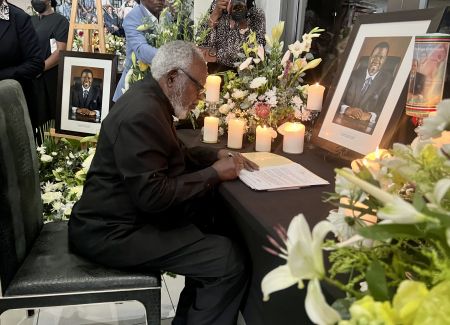 WINDHOEK, 07 February 2024 - Founding President Sam Nujoma signing the book of condolences for the late President Hage Geingob. Nujoma was accompanied by his wife Kovambo Nujoma. (Photo by: Linea Dishena) NAMPA 