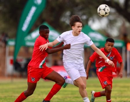 WINDHOEK, 22 May 2024 - National Under-17 player (in red) while in action against Westphalia at the Legare Stadium in Gobabis during a friendly match ahead of fixtures in the Namibian Newspaper Cup. (Photo by: Hesron Kapanga) NAMPA 