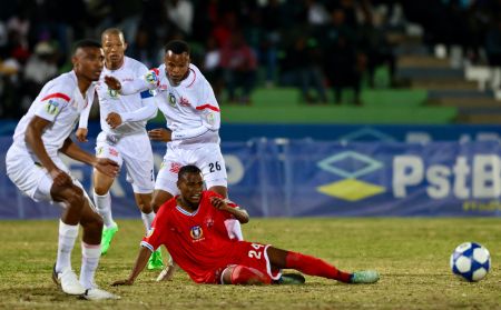 WINDHOEK, 28 July 2024 – African Stars striker (red) and Young Brazilian (white) in action at the Independence Stadium during the final of the 2024 PstBet Namibia Football Association (NFA) Cup. (Photo by: Hesron Kapanga) NAMPA