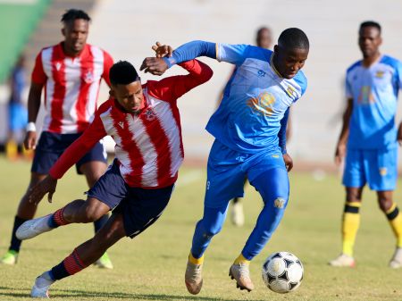 WINDHOEK, 11 August 2024 - African Stars player Edmund Kambanda (in white and red) in action against Tlotlo Kgaolo of Township Rollers during a friendly match at the Independence Stadium as part of their preparation for the CAF Confederations Cup preliminary qualifiers. (Photo by: Hesron Kapanga) NAMPA