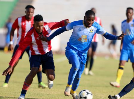 WINDHOEK, 11 August 2024 - African Stars player Edmund Kambanda (in white and red) in action against Tlotlo Kgaolo of Township Rollers during a friendly match at the Independence Stadium as part of their preparation for the CAF Confederations Cup preliminary qualifiers. (Photo by: Hesron Kapanga) NAMPA