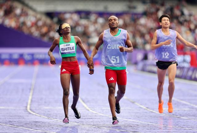 PARIS, 30 August 2024 - Namibia's T11 Paralympic sprinter, Lahja Ishitile and her guide Sem Shimanda cross the line in the T11 400 metre race, which was their opening race of the Paris 2024 Paralympic Games. (Photo by: Hesron Kapanga) NAMPA