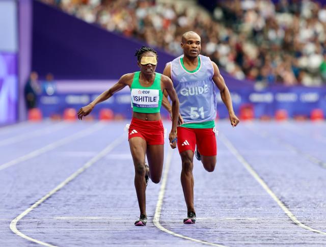 PARIS, 30 August 2024 - Namibia's T11 Paralympic sprinter, Lahja Ishitile and her guide Sem Shimanda cross the finish line in the T11 400 metre race, which was their opening race of the Paris 2024 Paralympic Games, at the Stade de France. (Photo by: Hesron Kapanga) NAMPA