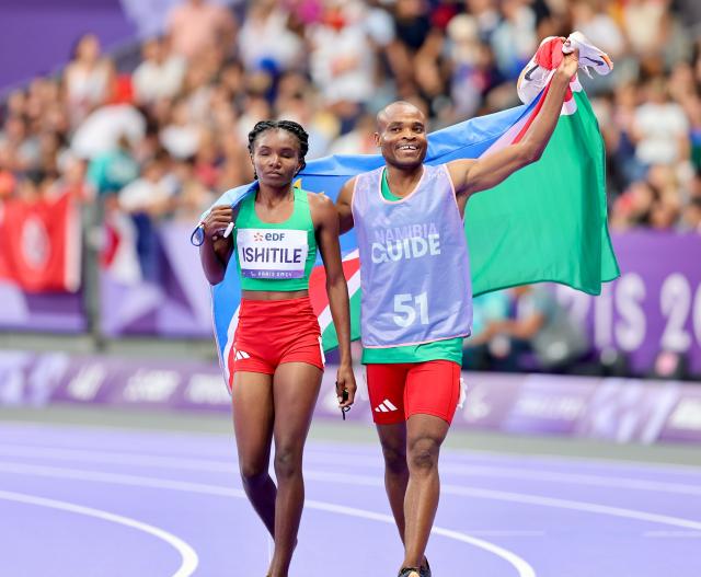 PARIS, 31 August 2024 – Paralympic sprinter Lahja Ishitile and her guide Sem Shimanda celebrating after winning a gold medal at the Paris 2024 Paralympic Games and setting a new Paralympic record in the women’s T11 400 metre race. Ishitile and Shimanda clocked 56.20 seconds to win gold at the Stade de Paris. (Photo by: Hesron Kapanga) NAMPA
