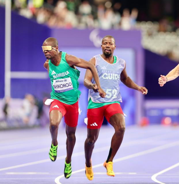 PARIS, 04 September 2024 – Namibian sprinter Ananias Shikongo and his guide Even Tjiuiju in action during the semi-final heats of the men’s T11 100-meter race at the Stade de France. (Photo by: Hesron Kapanga) NAMPA