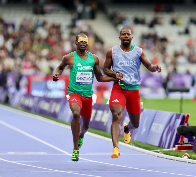 PARIS, 05 September 2024 – Namibia’s 2016 Paralympic Games gold medalist Ananias Shikongo and his guide Even Tjiuiju pictured in action during the final of the men’s T11 100-meter race at the Stade de France during the Paris 2024 Paralympic Games. (Photo by: Hesron Kapanga) NAMPA
