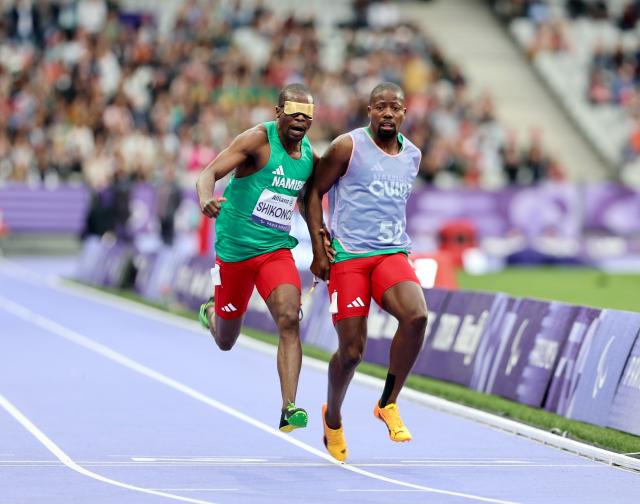 PARIS, 05 September 2024 – Namibia’s 2016 Paralympic Games gold medalist Ananias Shikongo and his guide Even Tjiuiju in action during the final of the men’s T11 100-meter race at the Stade de France during the Paris 2024 Paralympic Games. (Photo by: Hesron Kapanga) NAMPA