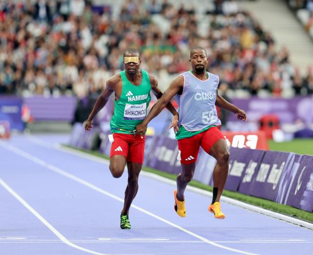 PARIS, 05 September 2024 – Namibia’s 2016 Paralympic Games gold medalist Ananias Shikongo and his guide Even Tjiuiju in action during the final of the men’s T11 100-meter race at the Stade de France during the Paris 2024 Paralympic Games. (Photo by: Hesron Kapanga) NAMPA