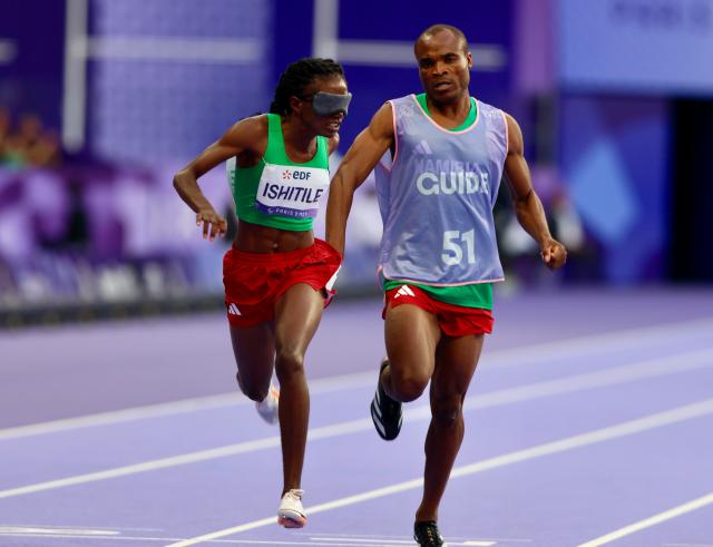 PARIS, 07 September 2024 – Paralympic sprinter Lahja Ishitile and her guide Sem Shimanda winning Namibia’s second medal at the Paris 2024 Paralympic Games after finishing third in the women’s T11 200 metre (m) race at the Stade de Paris. (Photo by: Hesron Kapanga) NAMPA