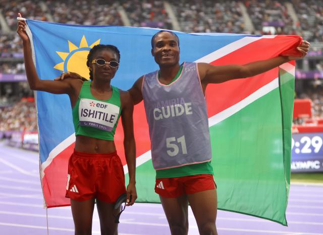 PARIS, 07 September 2024 – Paralympic sprinter Lahja Ishitile and her guide Sem Shimanda celebrating after winning Namibia’s second medal at the Paris 2024 Paralympic Games after they finished third in the women’s T11 200 metre (m) race at the Stade de Paris. (Photo by: Hesron Kapanga) NAMPA