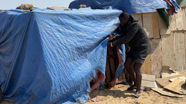 WALVIS BAY, 05 October 2024 - Herman Fillipus, whose home is just a few metres from the burnt-down shacks, lives in a temporary shelter made of plastic and sacks lives in constant fear of losing his belongings to the constant shack fires experienced at Otweya Informal settlement. (Photo by: Isabel Bento) NAMPA