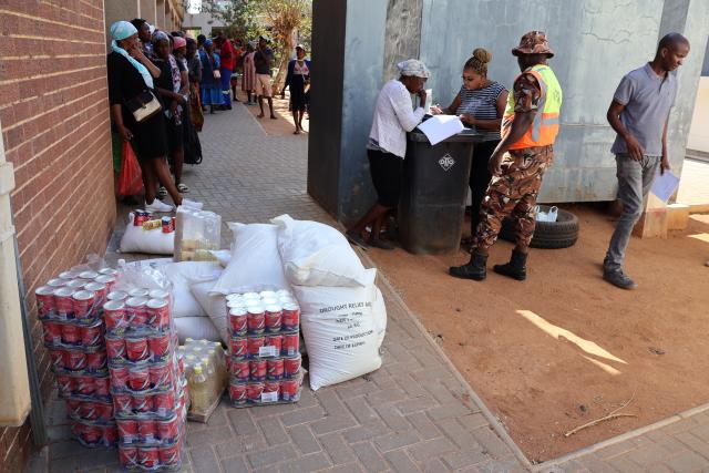 OTJIWARONGO, 16 OCTOBER 2024 - Officials of the Otjiwarongo Constituency office distributes food parcels for the government's drought relief programme at Otjiwarongo on Wednesday morning. (Photo bY Mulisa Simiyasa) NAMPA