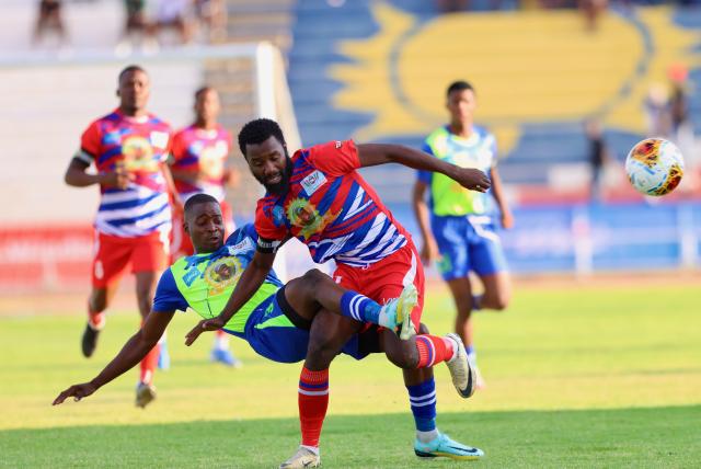 WINDHOEK, 19 September 2024 - Eeshoke Chula - Chula player Mwanyekange Matheus (in lime green) and Ibroihim Youssouf (in red and white) while in action during the Dr Hage Geingob Cup Cup final at the Independence Stadium. (Photo by: Hesron Kapanga) NAMPA