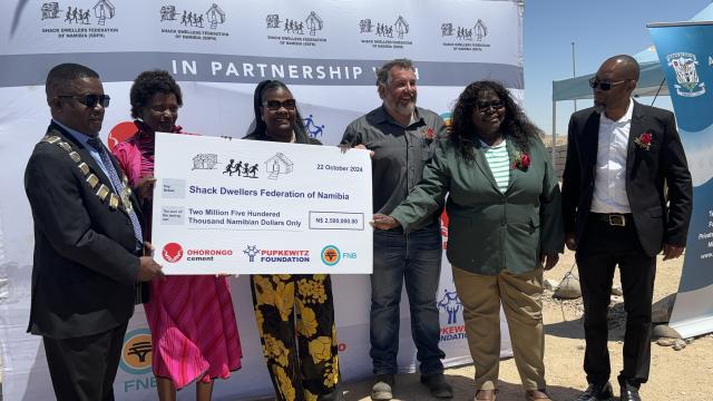 ARANDIS, 22 October 2024 - Deputy Minister of Urban and Rural Development Evelyn !Nawases-Taeyele, Chaiperson of the Erongo Regional Council Management Committee Benitha Imbamba and Arandis Mayor Risto Kapenda, receiving a cheque jointly donated by FNB, Ohorongo Cement and The Pupkewitz Foundation to the Shack Dwellers Federation for the construction of houses in several towns across the country. (Photo by: Isabel Bento) NAMPA