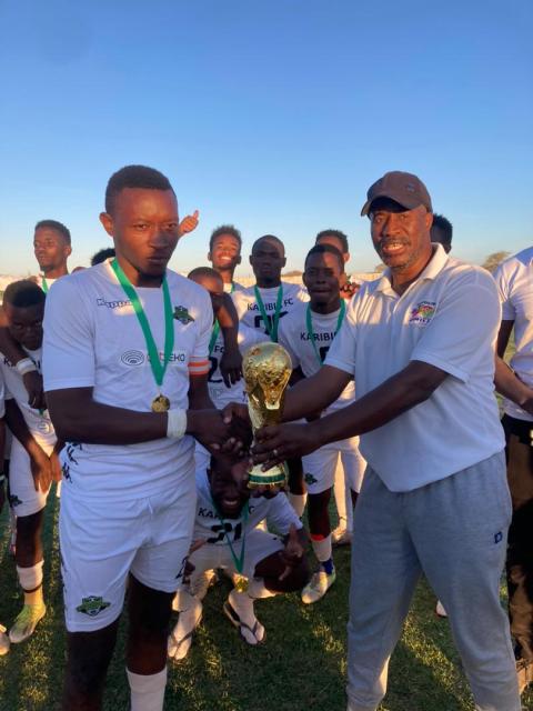 KARIBIB, 27 OCTOBER - Top Score Mayoral Cup organiser Elvin Majiedt (right) presenting the trophy to Karibib FC captain during the final phase of the Top Score tourney that saw the Karibib based outfit reigning supreme. (Photo: Contributed) NAMPA.