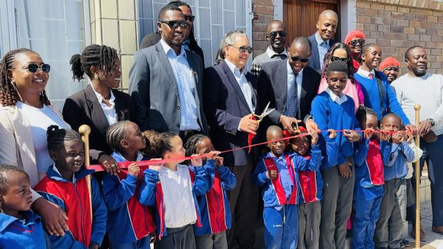 SWAKOPMUND, 29 October 2024 - Erongo Governor Neville Andre Itope, Westside High School principal Venezia Rheeder, Swakop Uranium management and corporate services employees photographed with some of the beneficiaries of the newly revamped school feeding facility inaugurated at the school at Tuesday. (Photo by: Isabel Bento) NAMPA