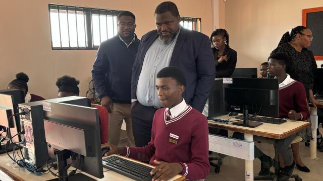 SWAKOPMUND, 07 NOV (NAMPA) - Swakop Uranium Executive Vice President Irvine Simaata watching on as one of the students at Matutura Secondary School uses one of the computers in the newly inaugurated computer room donated to the school by the Swakop Uranium Foundation. (Photo by: Isabel Bento) NAMPA