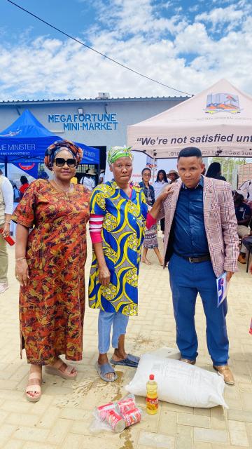 Windhoek 18 November 2024- The governor of Windhoek Laura Katjirua (left), Council of Windhoek Rural constituency Piet Adam (right) and a beneficiary (middle) during the launch of the e-voucher. 
(Photo: Ester Hakaala)