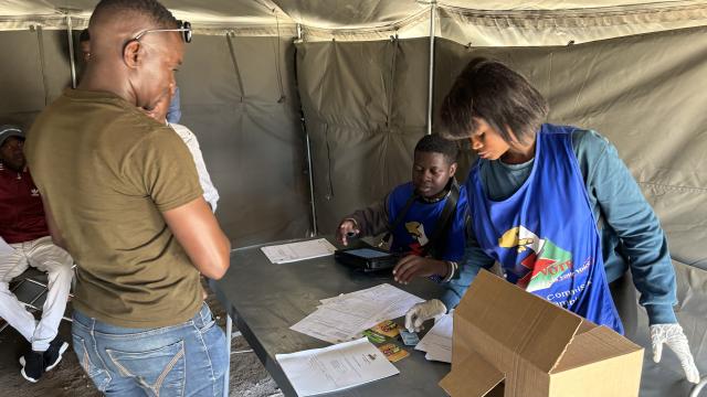 ARANDIS, 27 November 2024 - Polling officers attending to voters at a polling station at Arandis. The polling officer on the right is seen holding a verifier (Photo by: Isabel Bento) NAMPA