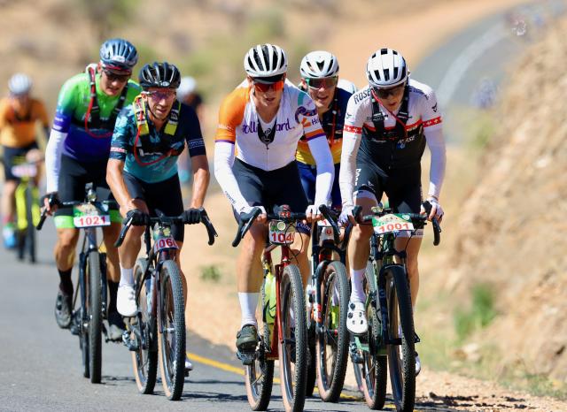 WINDHOEK, 06 December 2024 - Swiss rider Konny Looser on a (1001) bicycle and other Nedbank Desert Dash rider while climbing a hill en route to Kupferberg during the 2024 edition of the Nedbank Desert Dash. (Photo by: Hesron Kapanga) NAMPA