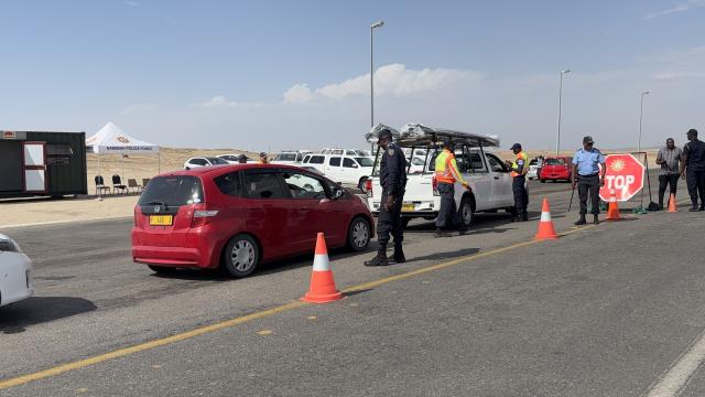 SWAKOPMUND, 11 December 2024 - Law enforcement officers in the Erongo Region checking vehicles at a checkpoint as part of the festive season safety campaign. The campaign which commenced on 15 November 2024 and will run until 17 January 2025 will focus on loads on vehicles, execution of warrant of arrest, roadworthiness of motor vehicles, among others. (Photo by: Isabel Bento) NAMPA