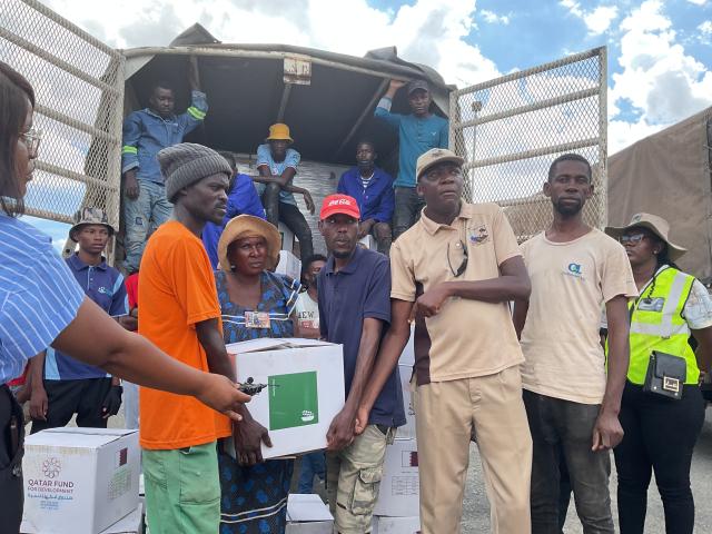 WINDHOEK, 06 January 2025 - Khomasdal Constituency Councillor, Samuel Angolo pictured with flood victims during the handing over of food aid on Monday. (Photo by: Eba Kandovazu)