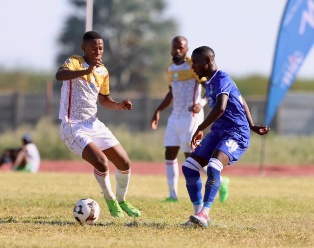 OSHAKATI, 02 January 2025 - UNAM FC football player (left) and Blue Waters player (right) while in action during the quarterfinals of the MTC Maris Cup at the Oshakati Independence Stadium. (Photo by: Hesron Kapanga) NAMPA