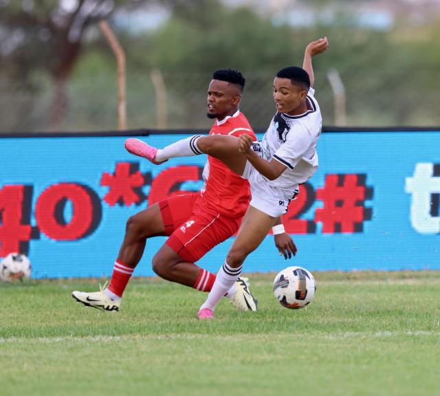 Mariental, 08 March 2025 - African Stars, Romario Ndjavera  (in red) while in action against Giovanni Engelbrecht of Bucs Buccaneers during the semi-final of the MTC Maris Cup at the Mariental Stadium. (Photo by: Hesron Kapanga) NAMPA 