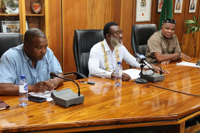 OTJIWARONGO, 18 March 2025 - Otjiwarongo Mayor, Gottlieb Shivute (M) on Tuesday speaks at the media briefing where he outlined a detailed municipality masterplan for the reconstruction of several street roads at the town. Left is the municipality chief executive officer, Mberipura Hifitikeko and chairperson of the management committee, Godhard Hoko. (Photo by: Mulisa Simiyasa) NAMPA