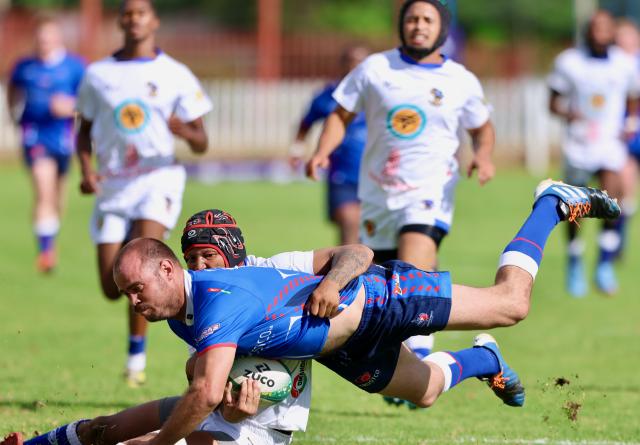 WINDHOEK, 06 April 2025 – Trustco United Rugby Club player (in blue) while in action against Kudus during round three of the Namibia Rugby Premier League at  at Trustco United Park. (Photo by: Hesron Kapanga) NAMPA