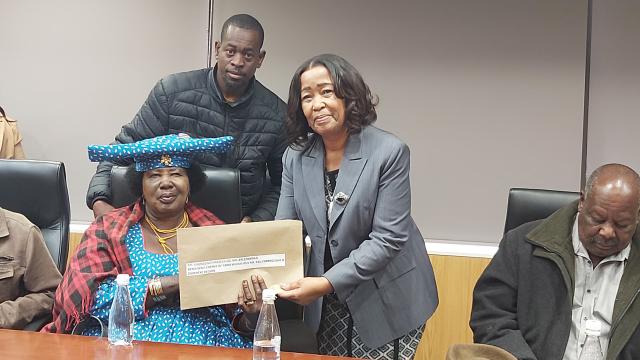 Minister of Agriculture, Fisheries, Water, and Land Reform Ingenesia Zaamwani(Right) pictured handing over an allotment letter to one of the nine beneficiaries (Photo by:Negumbo Ali) NAMPA