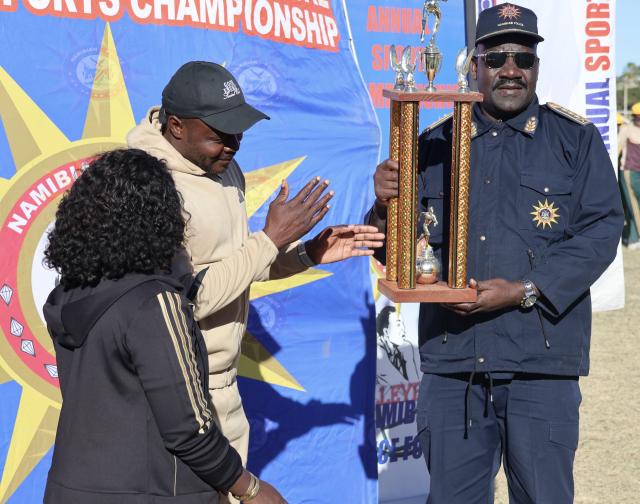 OTJIWARONGO, 28 June 2025 - Members of the Namibian Police Force (NamPol) from the Oshana Region at the 28th NamPol championship games at Otjiwarongo receives a trophy from the NamPol Inspector-General, Lieutenant-General Joseph Shikongo (R) on Saturday afternoon.  (Photo by: Mulisa Simiyasa) NAMPA