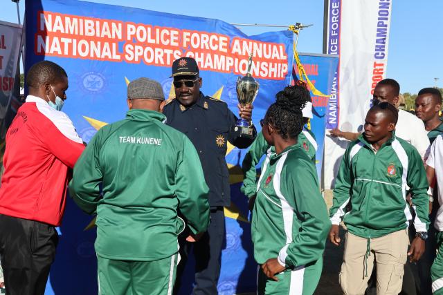 OTJIWARONGO, 28 June 2025 - Members of the Namibian Police Force (NamPol) from the Kunene Region at the 28th NamPol championship games at Otjiwarongo receives a trophy from the NamPol Inspector-General, Lieutenant-General Joseph Shikongo (C) on Saturday afternoon.  (Photo by: Mulisa Simiyasa) NAMPA