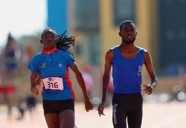 SWAKOPMUND, 08 July 2025 - T12 female sprinter, Ndapewa iipinge and guide Filipus Kotokeni while in action dureing the final of the 100 metres race and the Veneta Stadium during the African Union Sport Council (AUSC) Region Five Youth Games in Swakopmund. (Photo by: Hesron Kapanga) NAMPA