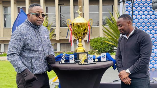 WALVIS BAY, 20 AUGUST 2025 - Namport’s Executive for Commercial Services, Elias Mwenyo and PINDULO Namibia Business Development Director Festus Tautinge unveiling the floating trophy for Namport’s first-ever 7-A-SIDE soccer tournament taking place at Walvis Bay this weekend. (Photo by: Isabel Bento) NAMPA