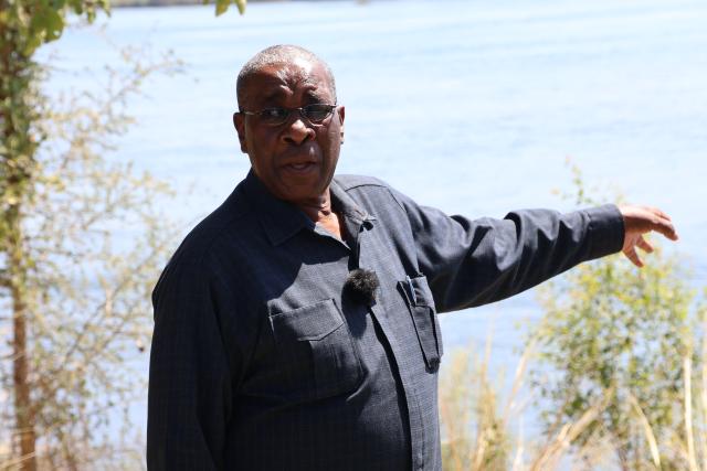 KATIMA MULILO, 22 August 2025 - Former Zambezi Region Governor, Lawrence Sampofu points out where the first commander of the People's Liberation Army of Namibia (PLAN) Tobias Hainyeko was shot and killed on 18 May 1967 at Katima Mulilo near Namwi Island. (Photo by: Mulisa Simiyasa) NAMPA 