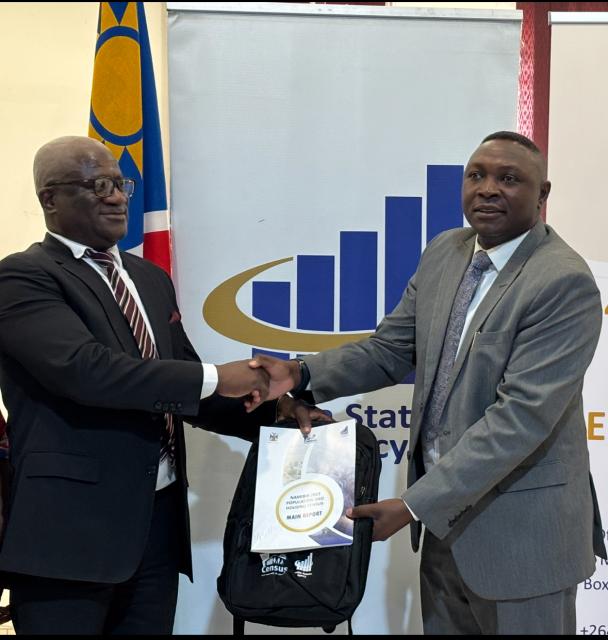 RUNDU, 16 September 2025 - The Namibia Statistics Agency GIS and NSDI Coordination Executive Alex Mudabedi handing the Namibia 2023 Population and Housing Census report to the Governor of the Kavango East region Hamunyera Hambyuka. (Photo by: Sawi Hausiku) NAMPA 