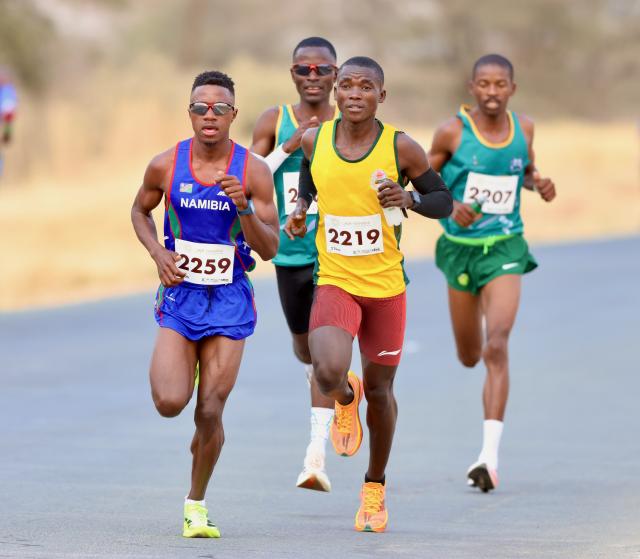 KARIBIB, 20 Sepetember 2025 - Long-distance runners representing the Namibian Police Force (NamPol) and Namibia Correctional Service, Matias Simon (in blue) and Simon Paulus (in yellow) while in action during the 11th edition of the QKR Namibia Navachab half-marathon in Karibib. (Photo by: Hesron Kapanga) NAMPA
