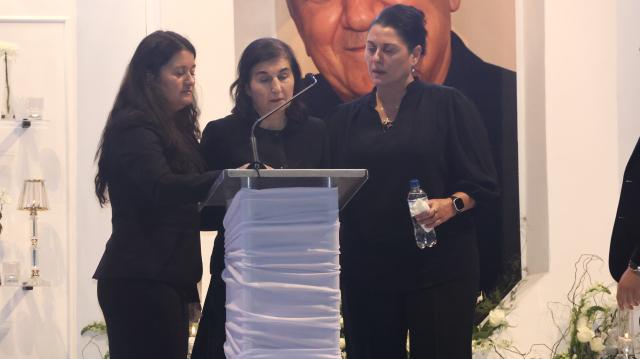 WALVIS BAY, 07 October 2025 - The wife of late Walvis Bay businessman John Savva, Roulla Savva sandwiched with their two daughters as she delivers a tribute to her late husband during a memorial service. (Photo by: Isabel Bento) NAMPA