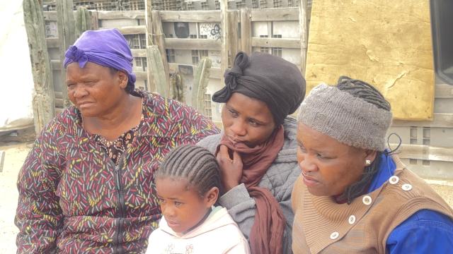 SWAKOPMUND, 20 October 2025 - 31 year old Zelda Goses (middle) the mother of the two little girls who died in a shack fire in DRC last week, seated with her aunt and sister, as well as one of her surviving daughter Veronica Goses. (Photo by: Isabel Bento) NAMPA