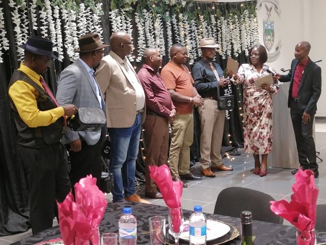 OTJIWARONGO, 24 October 2025 - The Otjozondjupa Regional Constituency Councillors line up to receive vouchers from the acting Chief Regional Officer, Shikongo Alweendo (R) being supported by the regional council director of planning, Vilma Guriras as councillors bid farewell Friday night to council staff-members at Otjiwarongo. (Photo by: Mulisa Simiyasa) NAMPA